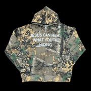 Jesus Can Heal What You're Hiding | Zip Up Hoodie