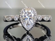 doveggs pear side stone moissanite engagement ring