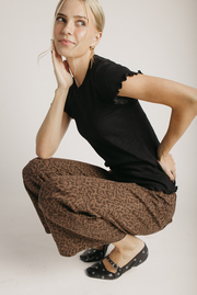 The Kyra Ruffle Hem Tee in Black