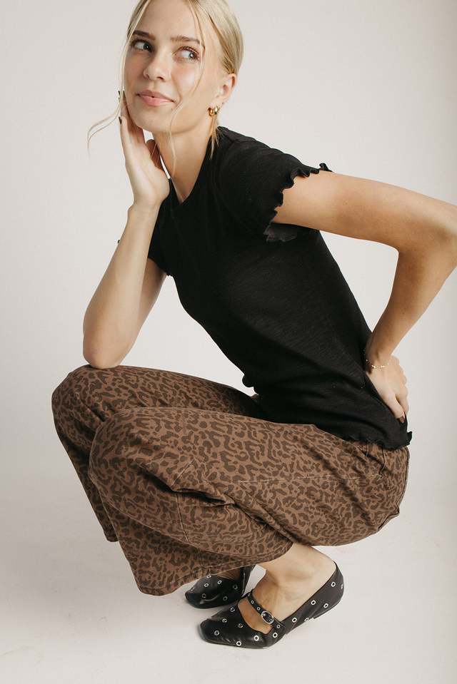 The Kyra Ruffle Hem Tee in Black