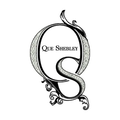 Que Shebley logo