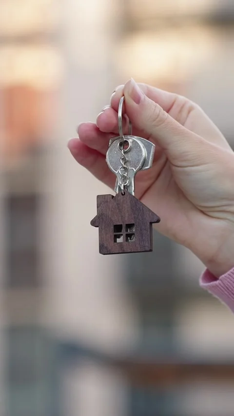 Vertical video new home close up woman holding keys homeowner real estate agent